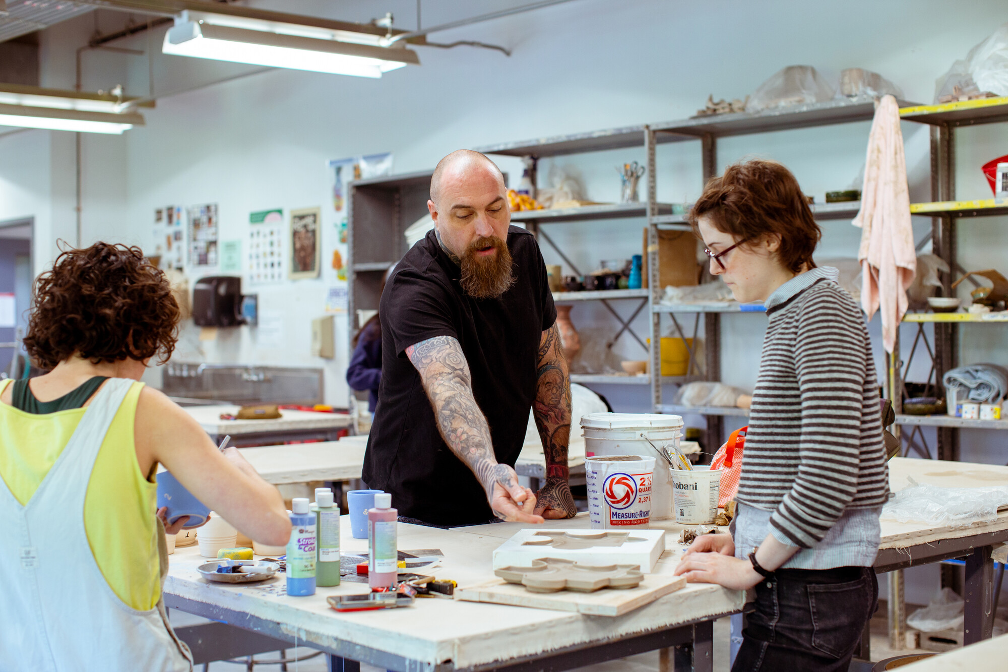 professor teaching craft students in the workshop
