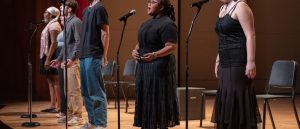 pre-college students singing on stage