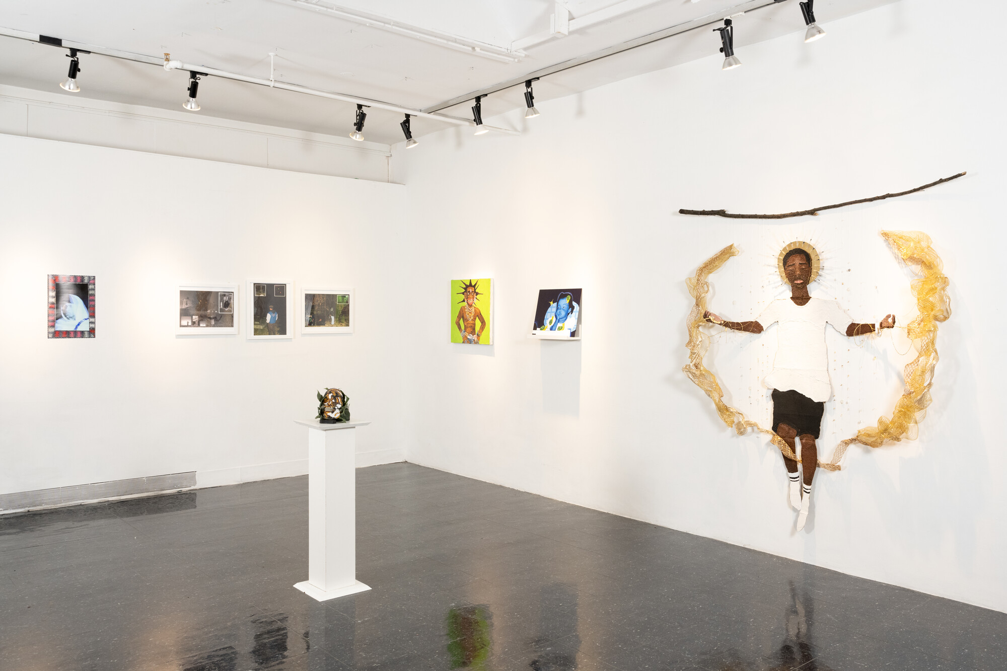 Exhibitoin View showing several paintings and a sculpture