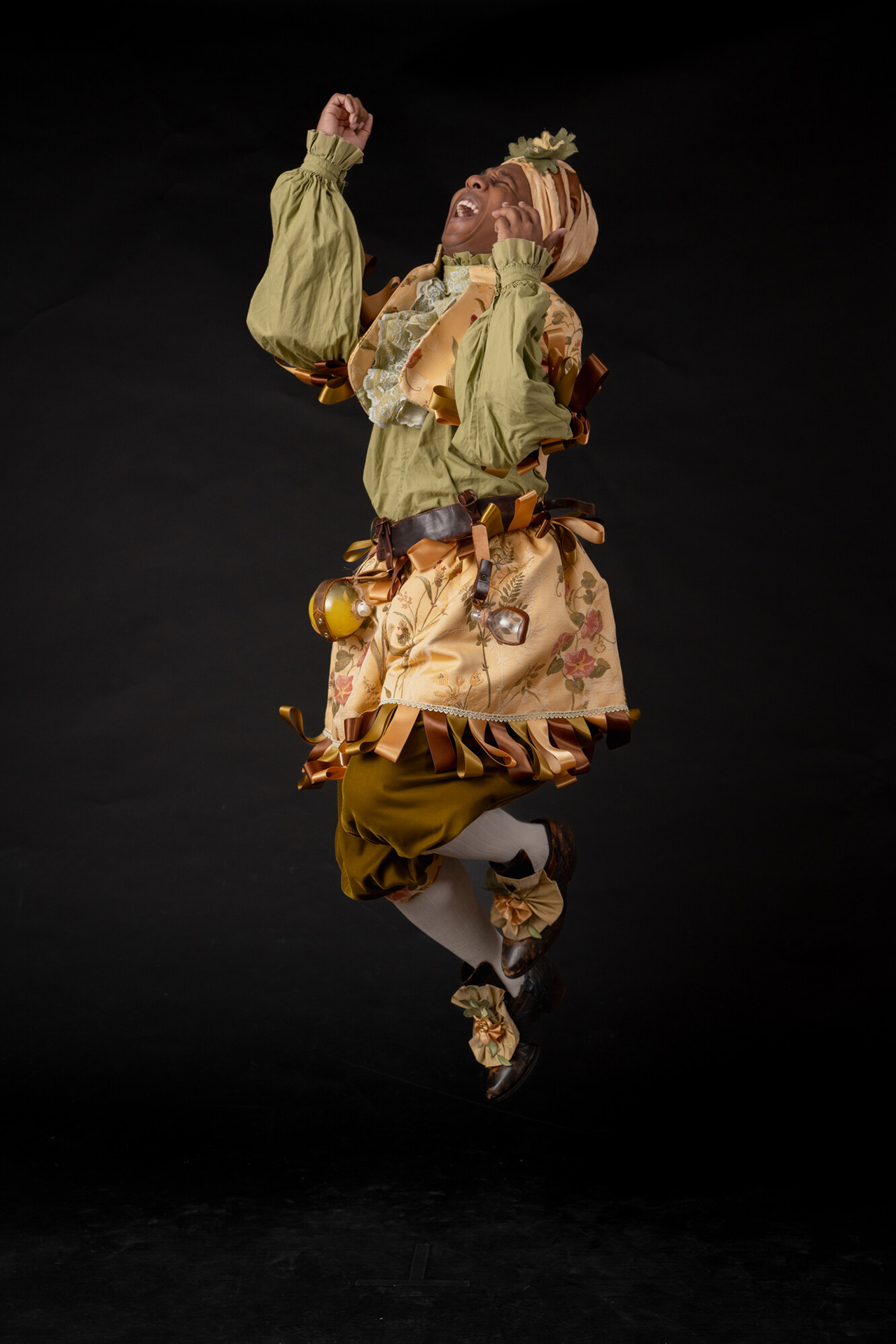 Brandon McLendon dressed as FLEURANT for the Imaginary Invalid Costume Shoot jumping in the air
