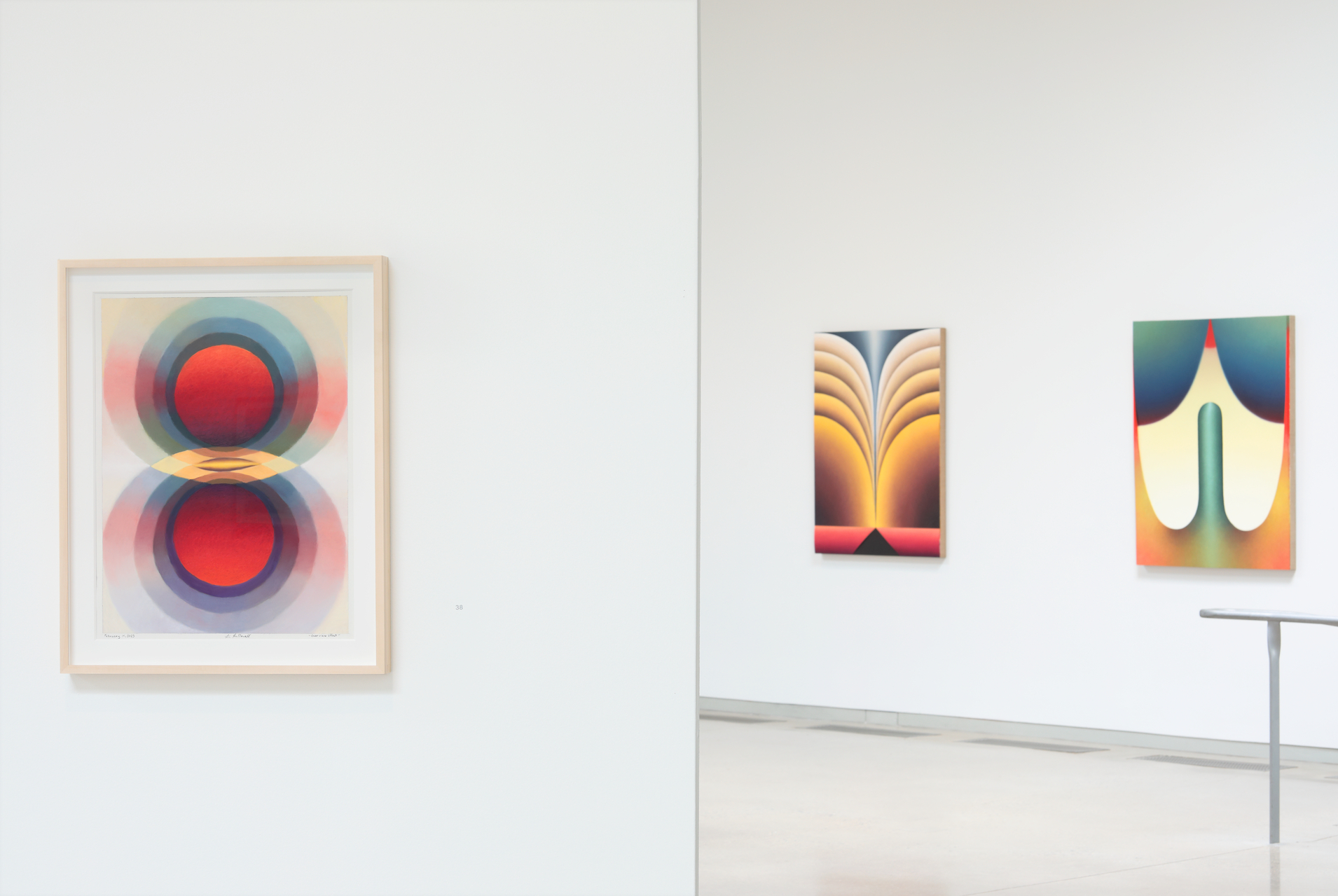 An exhibition view of Loie Hollowell's work showing two walls with 3 of Loie's brightly colored paintings of geometric and biomorphic forms.