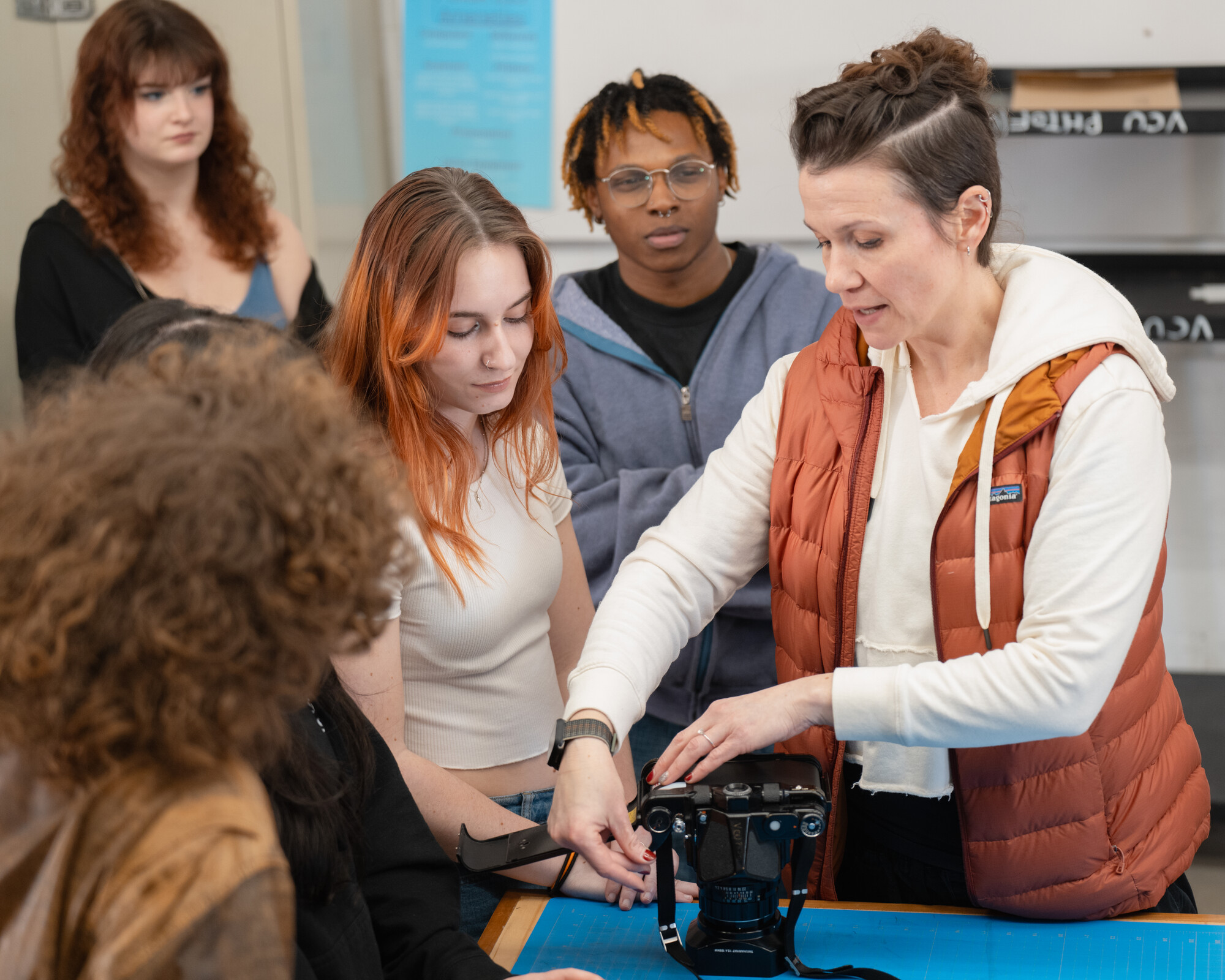 Photography students and faculty member in studio