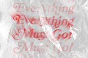 A shiny white plastic bag texture fills the screen. In the style of classic “thank-you” bags, red serif text exclaims “Everything Must Go!” The text is wispy at the ends