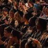 A male graduates walks across the stage at the VCUarts 2026 Commencement celebration.