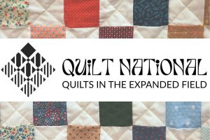 To the left is a geometric quilt square logo. On the right is text that reads, "Quilt National. Quilts in the Expanded Field."