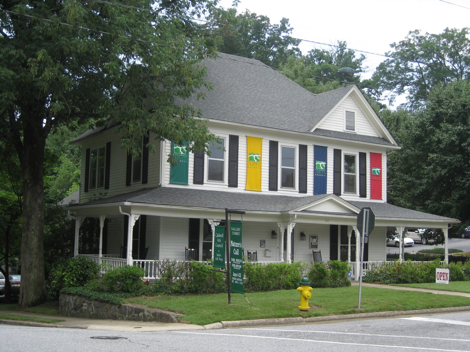 A suburban house with colorful banners hanging in between its windows.