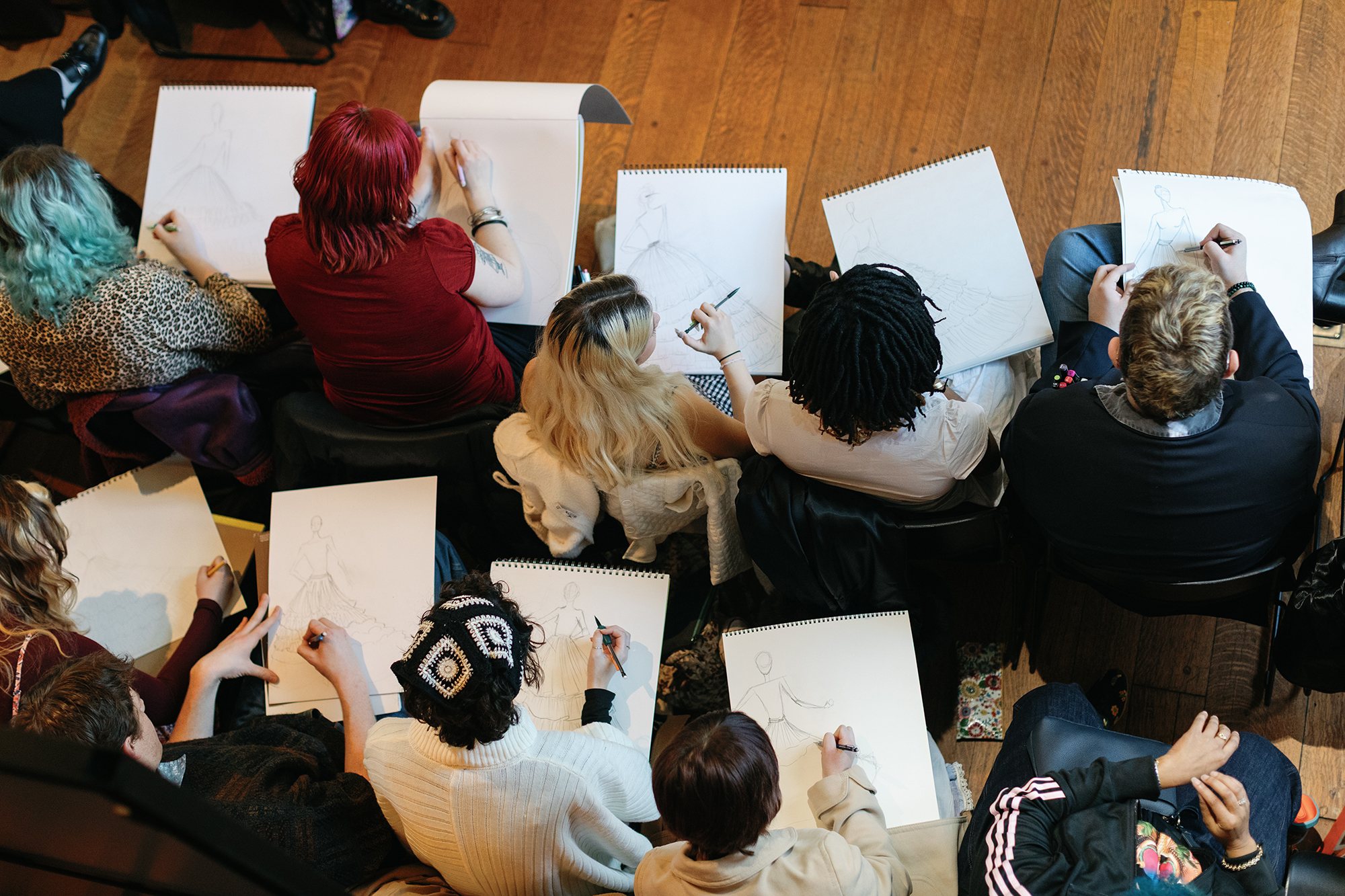 Students viewed from above during a sketching workshop with Christian Siriano